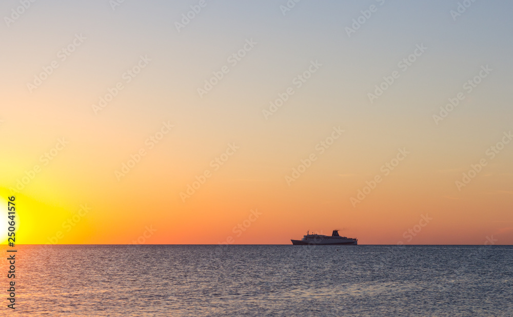 Cruise ship sailing in the sea at sunset 