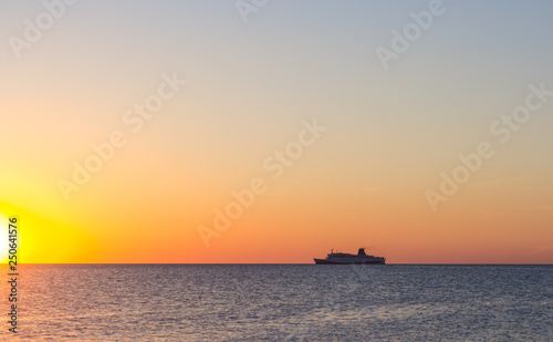 Cruise ship sailing in the sea at sunset  © Igor Luschay