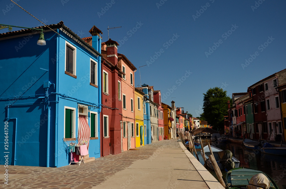 Colorful concept. Venice, Burano island canal, small colored houses and the boats