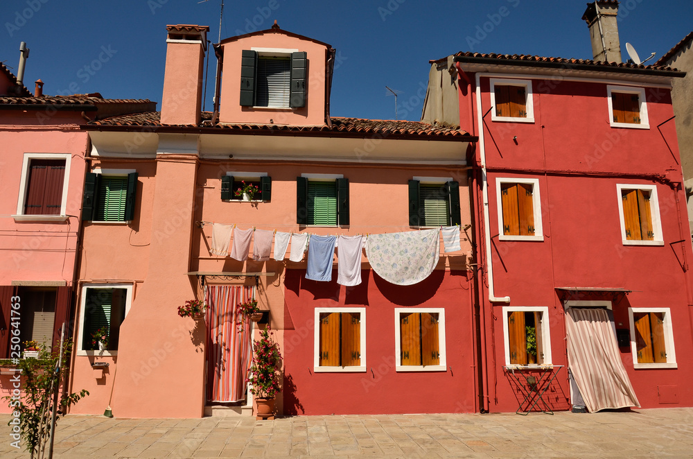 Venice, Burano, small colored houses. Colorful concept, orange and blue