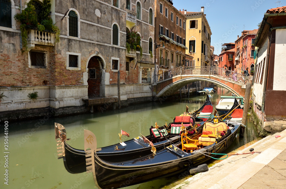 Gondola on Canal Grande. Gondolas moored on canal. Gondola service tourist people travel around Venice in Italy