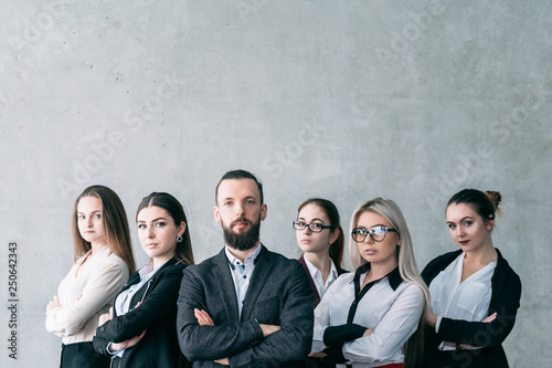 Confident business coach. Corporate coaching. Team of company professionals posing with arms crossed. Copy space on grey background.