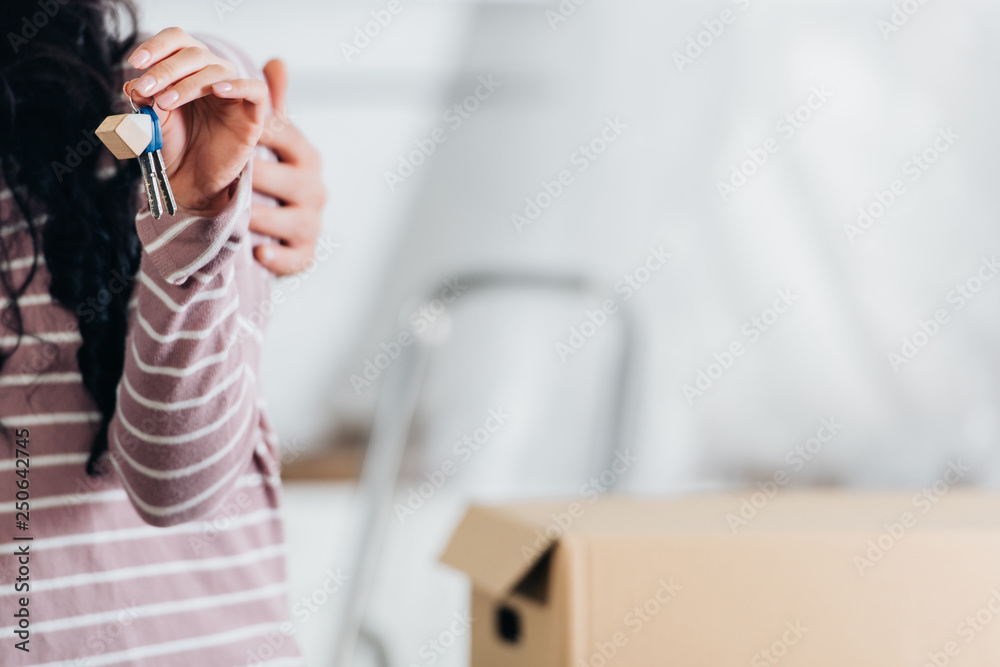 selective focus of woman holding keys from new home near husband