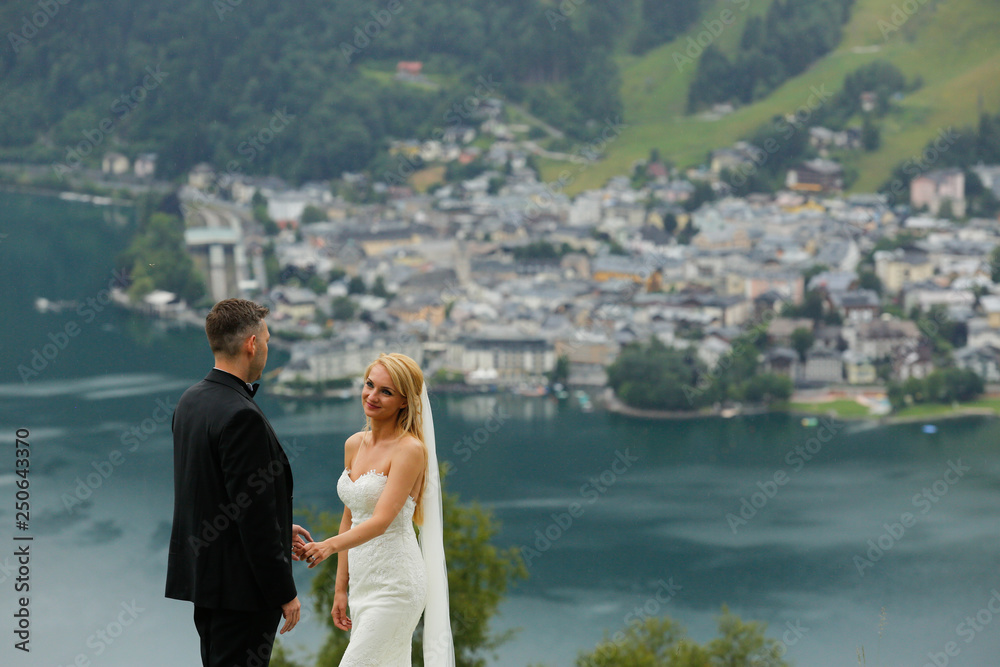 Wedding couple in love kissing and hugging near lake on beautiful landscape