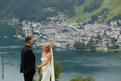 Wedding couple in love kissing and hugging near lake on beautiful landscape