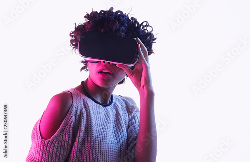 Astonished black teen girl exploring virtual reality