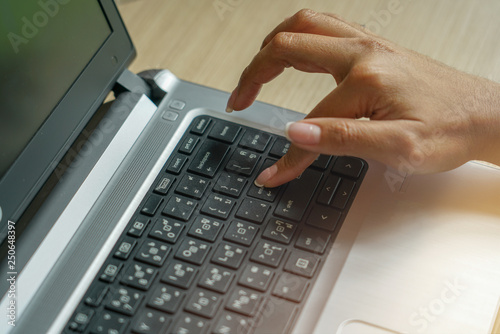 hands typing on laptop keyboard