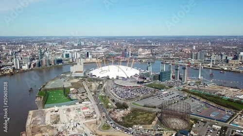 Aerial drone bird's eye view video cruising in river Thames near iconic concert Hall of O2 Arena, London, United Kingdom photo