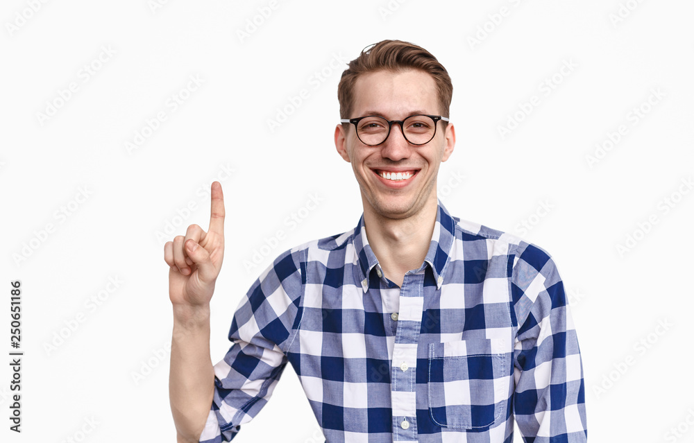 Cheerful guy in glasses pointing up Cheerful guy in glasses pointing up