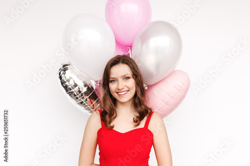 Cheerful lady hiding balloons behind back