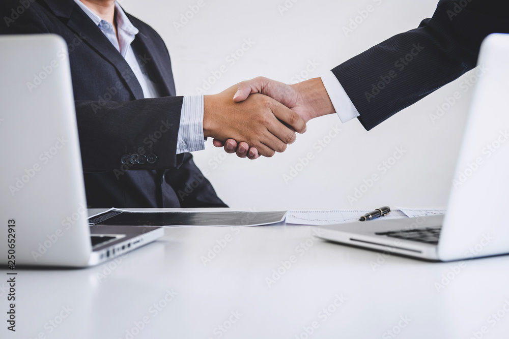 Business handshake after discussing and analysis graph stock market trading good deal of Trading to sign agreement and become a business partner, contract for both companies