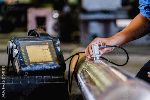 Ultrasonic test to detect imperfection or defect of round bar steel raw material in factory, NDT Inspection. photo