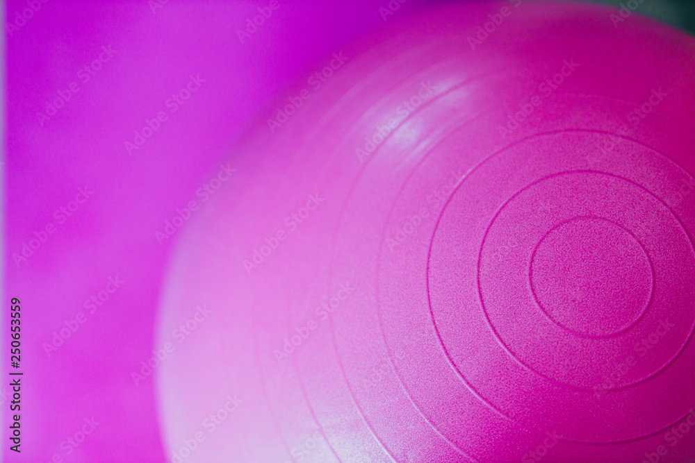 pink set of yoga mat and swiss fitness ball, concept of staying fit at home pink set of yoga mat and swiss fitness ball, concept of staying fit at home