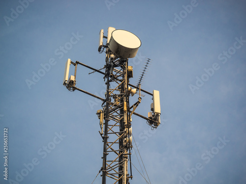 Base Station or Base Transceiver Station. Telecommunication tower. Wireless Communication Antenna Transmitter. Telecommunication tower with antennas against blue sky.
