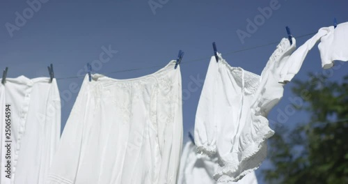 Laundry flapping on a clothesline ouside on a summer day