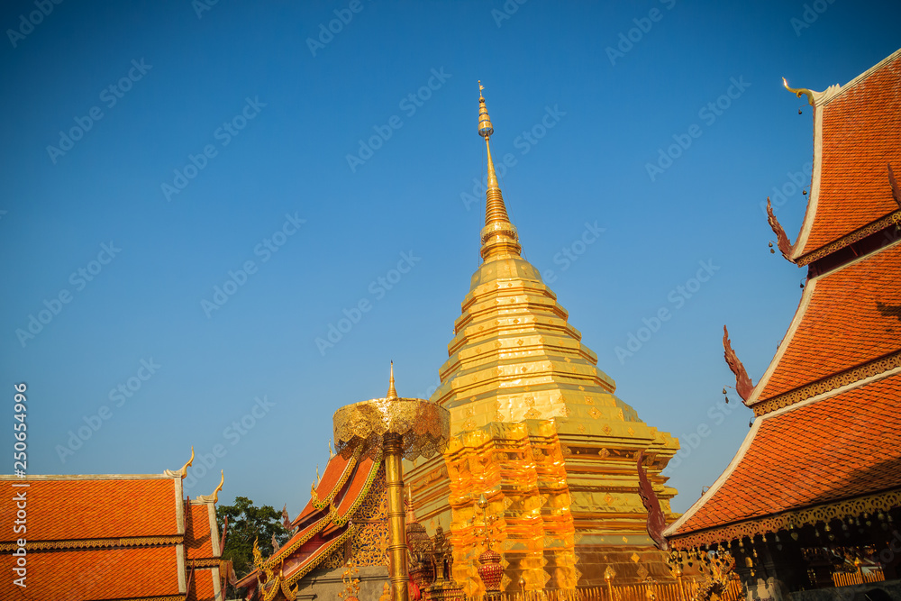 Fototapeta premium Beautiful northern Thai style architectural of golden church and pagoda at Wat Phra That Doi Suthep, the famous temple and became the landmark of Chiang Mai, Thailand.