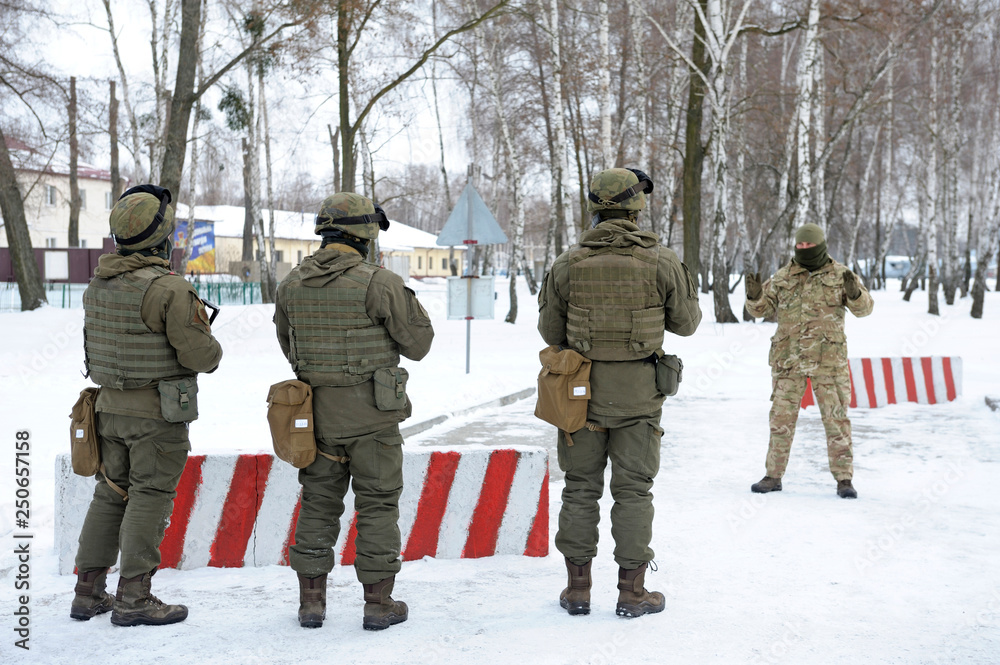 Officer instructing soldiers about guarding roadblock Officer instructing soldiers about guarding roadblock