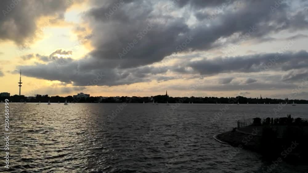 Alster lake in Hamburg, Germany, time lapse video footage 1080p with towering dramatic cloudscape at sunset Alster lake in Hamburg, Germany, time lapse video footage 1080p with towering dramatic cloudscape at sunset