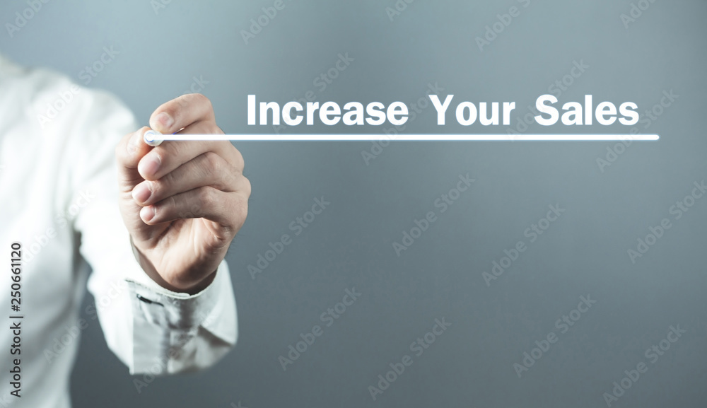 Man with pen write Increase Your Sales text in screen. Man with pen write Increase Your Sales text in screen.