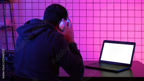 Gamer wearing headset watching stream of a game. White Display.