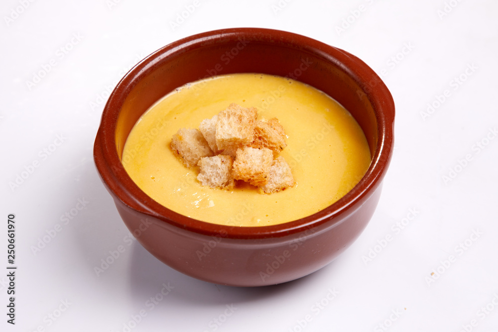 pumpkin cream soup with croutons on the white background pumpkin cream soup with croutons on the white background