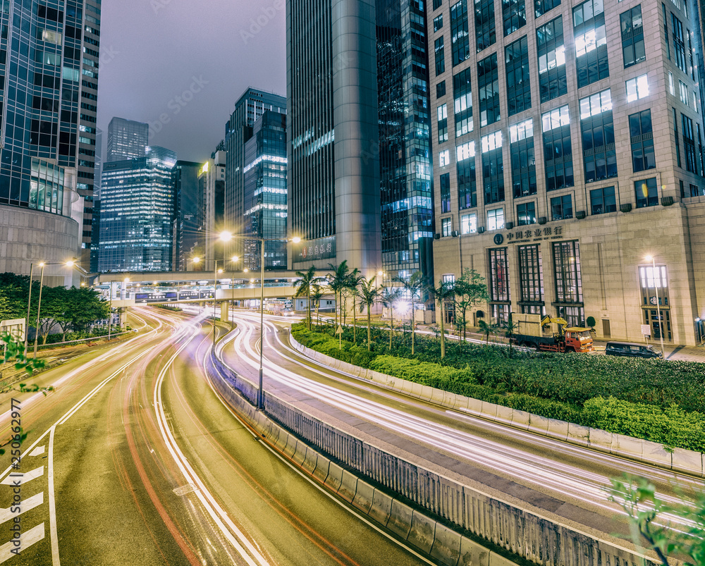 HONG KONG - MAY 10, 2014: City traffic at night. Hong Kong hosts 10 million tourists every year