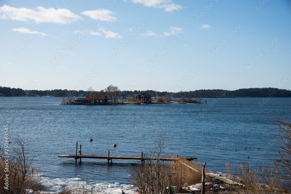 Jetty in Stockholm archipelago a sunny spring day with ice flakes