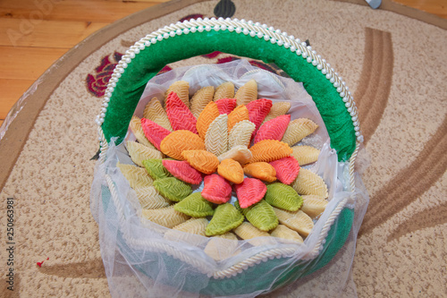 National Azerbaijan sweet pastry Colorfull shekerbura with nuts and honey on wooden table background, close up. Delicious dessert Colorfull Shekerbura baked during the spring holiday Novruz. Xoncha . photo