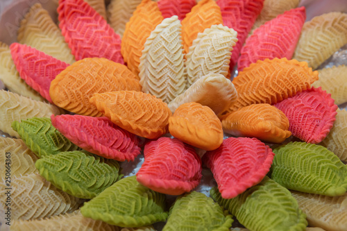 National Azerbaijan sweet pastry Colorfull shekerbura with nuts and honey on wooden table background, close up. Delicious dessert Colorfull Shekerbura baked during the spring holiday Novruz. photo