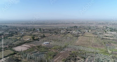 Aerial drone scene of rural landscape with little crops. Camera moving backwards at high altitude. Villa Union, Rioja province, Argentina photo