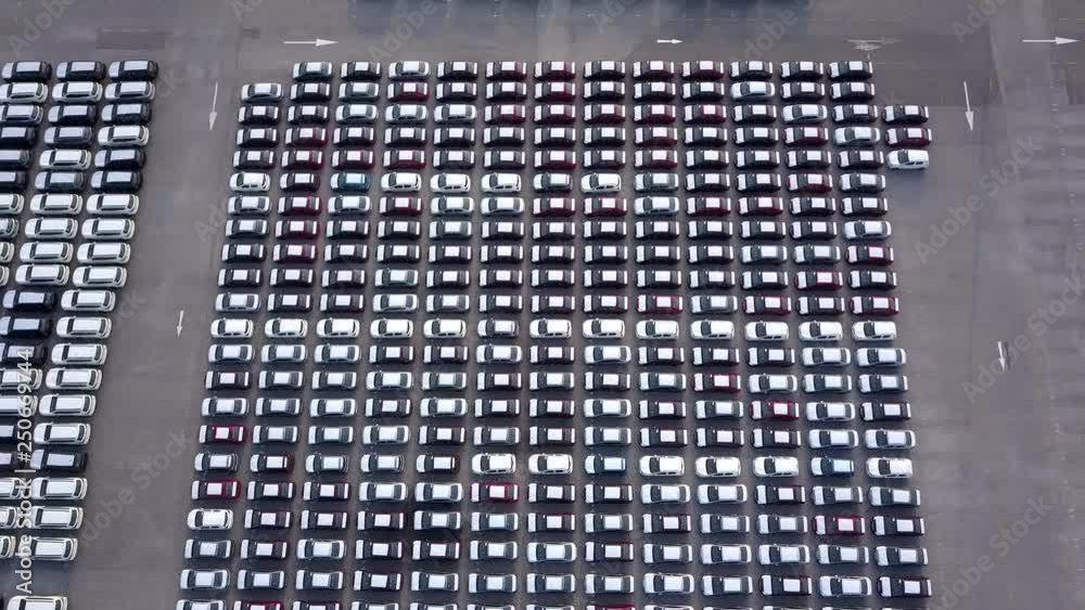 Aerial View of new cars parked at the parking area of automobile factory. Waiting for export and import at the international port. Aerial View of new cars parked at the parking area of automobile factory. Waiting for export and import at the international port.