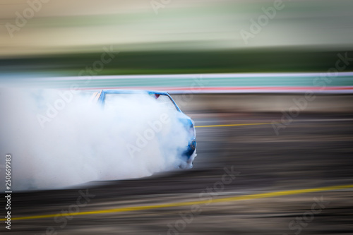 Blurred Race car drifting on speed track on twilight background.