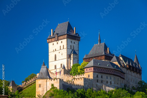 View of Karlstejn royal castle at sunny day, located near of Prague, Czech Republic, Europe.