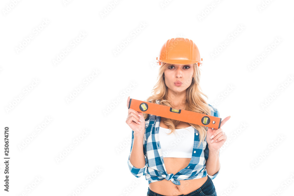 blonde architect woman in blue shirt and orange hardhat holding spirit level isolated on white blonde architect woman in blue shirt and orange hardhat holding spirit level isolated on white