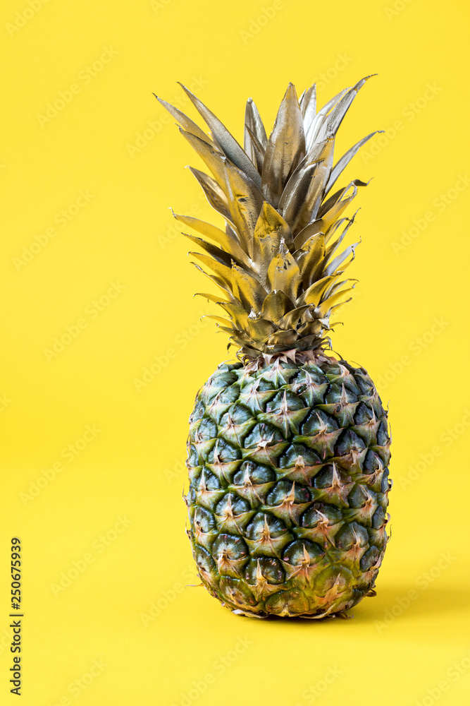 Creative layout made gold pineapple on brightly yellow background.Minimal style.  Tropical Food concept.Summer Idea .Copy space for Text.