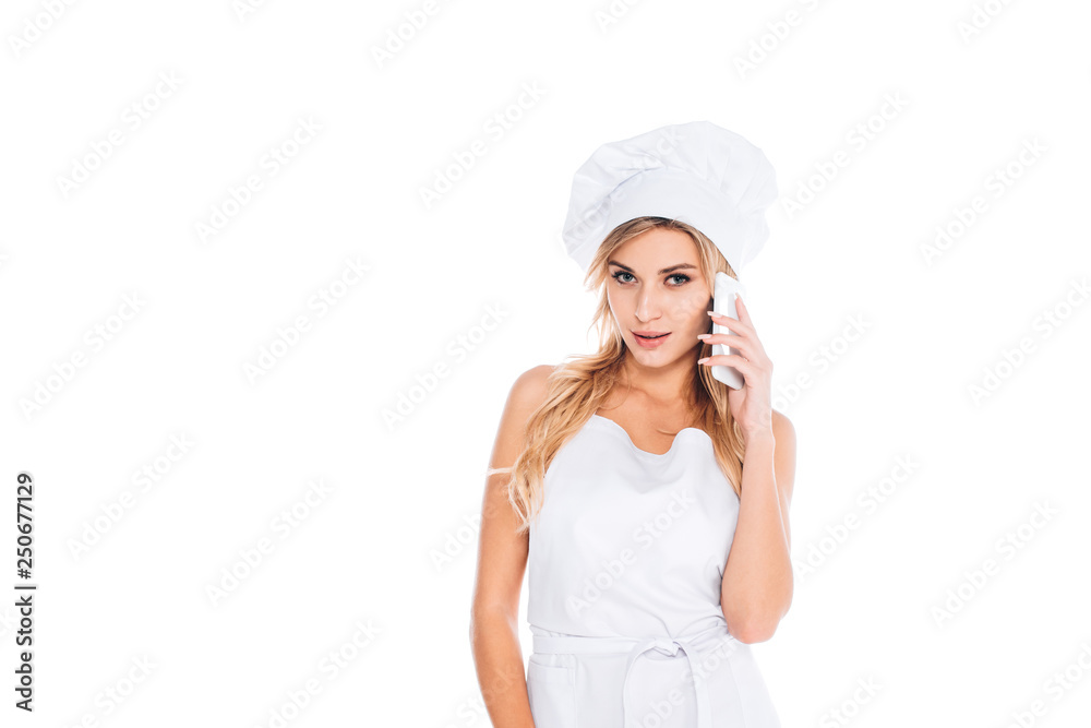 attractive blonde cook woman in uniform talking on smartphone isolated on white attractive blonde cook woman in uniform talking on smartphone isolated on white