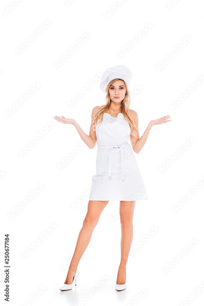 attractive blonde woman in cook uniform standing on white background