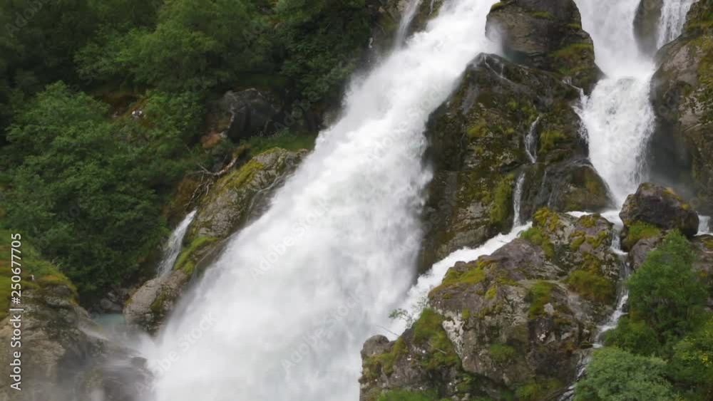 Kleivafossen waterfall near Briksdal glacier in Norway. Summer landscape. Norway nature and travel background. Kleivafossen waterfall near Briksdal glacier in Norway. Summer landscape. Norway nature and travel background.