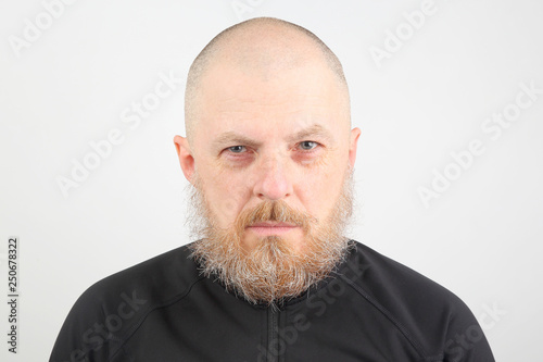 portrait of a bearded man on a light background