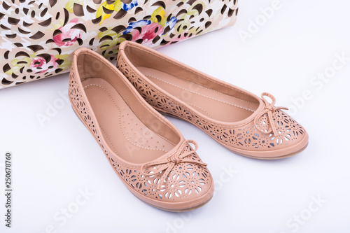 Pair of fashionable female shoes on white background