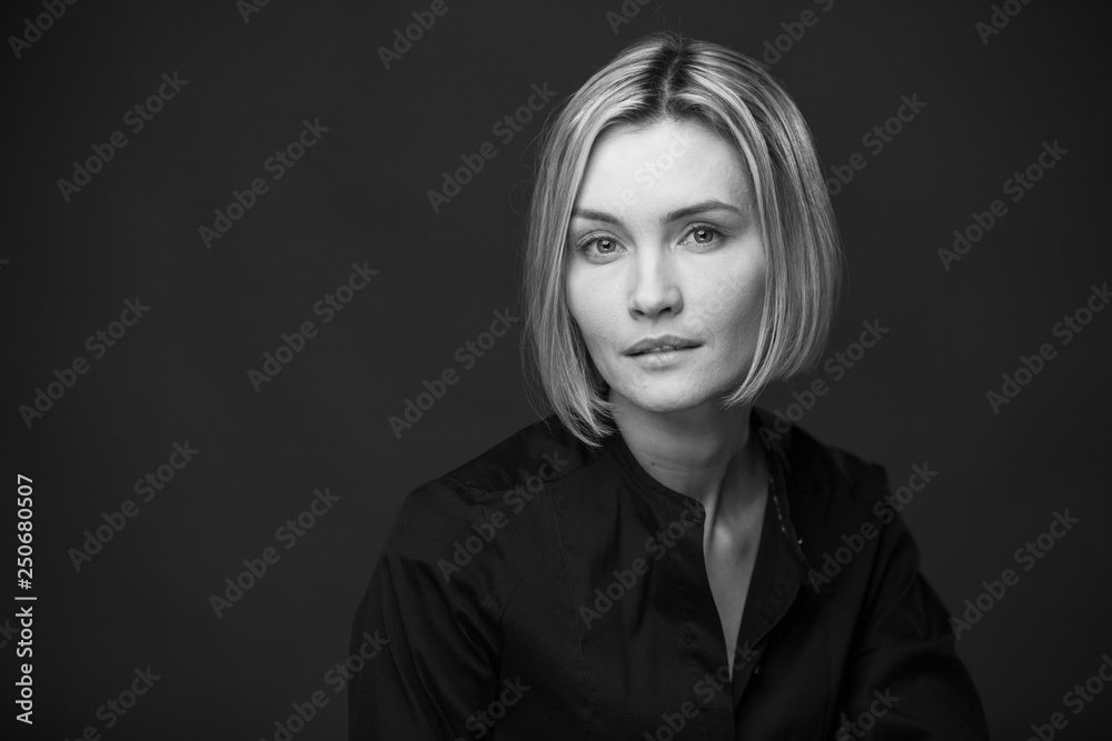 Dramatic black and white portrait of a beautiful woman on a dark background Dramatic black and white portrait of a beautiful woman on a dark background