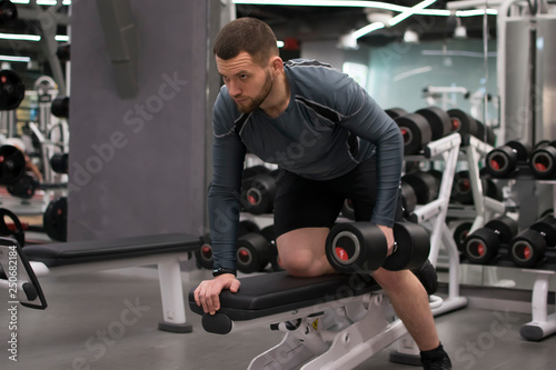 Man in the gym with kettlebells and weights.