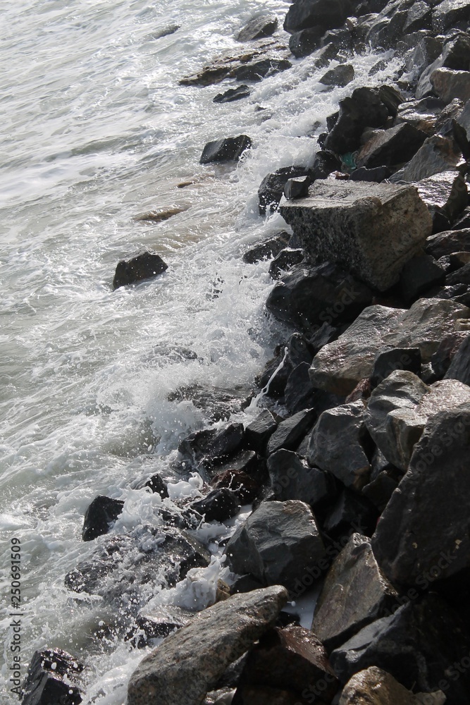 strong sea waves and foam with stones in the sea strong sea waves and foam with stones in the sea