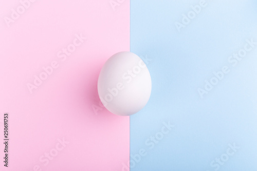 white egg on a pink blue background, concept Happy Easter