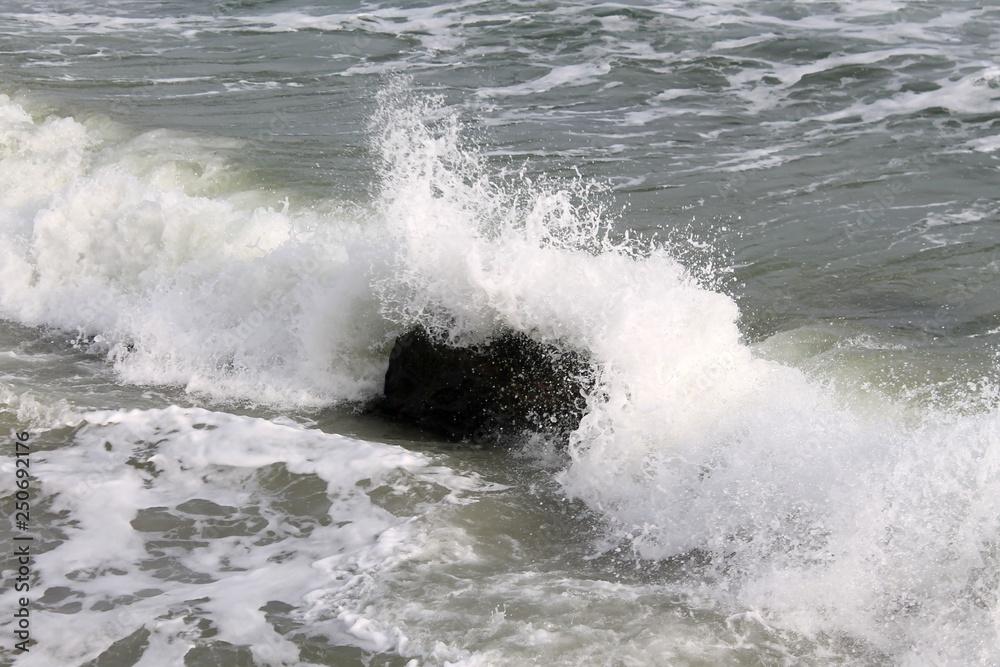 strong sea waves and foam with stones in the sea