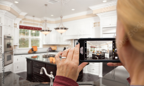 Fotografija Woman Taking Pictures of A Custom Kitchen with Her Smart Phone