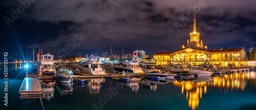 Marine Station of Sochi, illuminated with lights at night with reflection in water