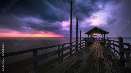 Vászonkép A dramatic rainy sunset in pontian kecil