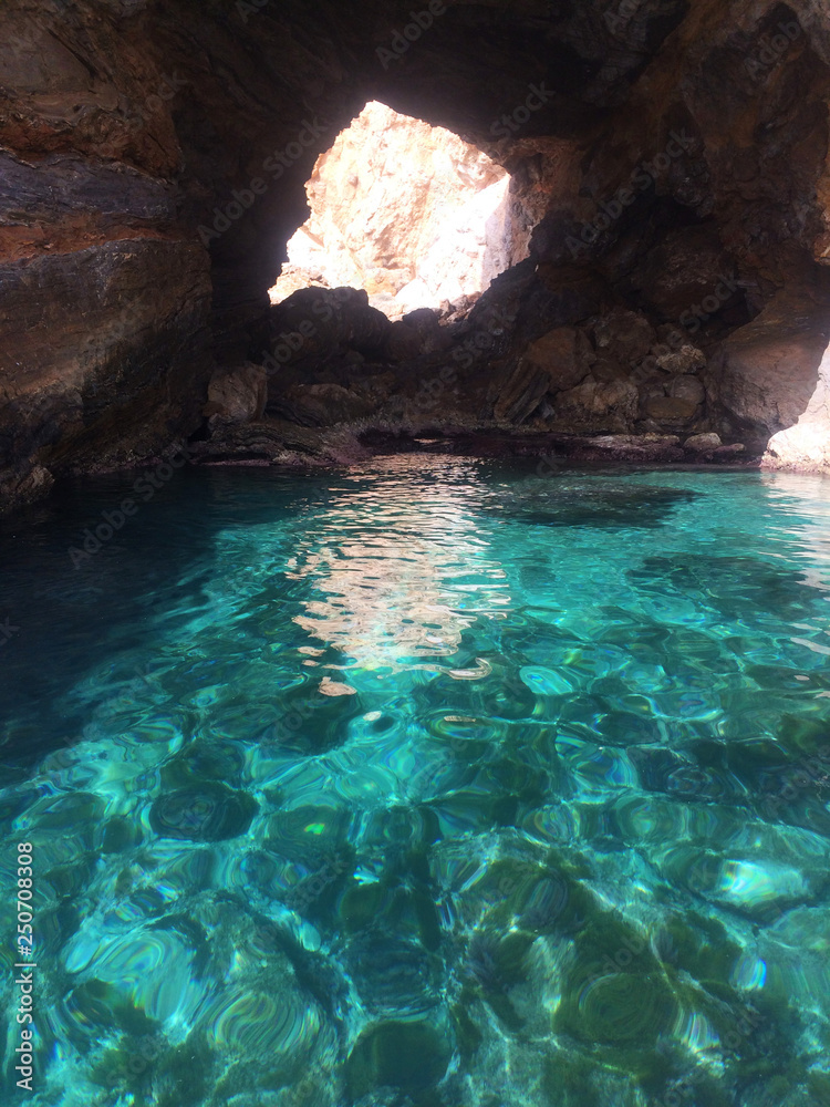 Small grotto and blue clean water
