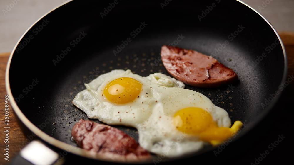 Fried eggs in a pan with sausage Fried eggs in a pan with sausage